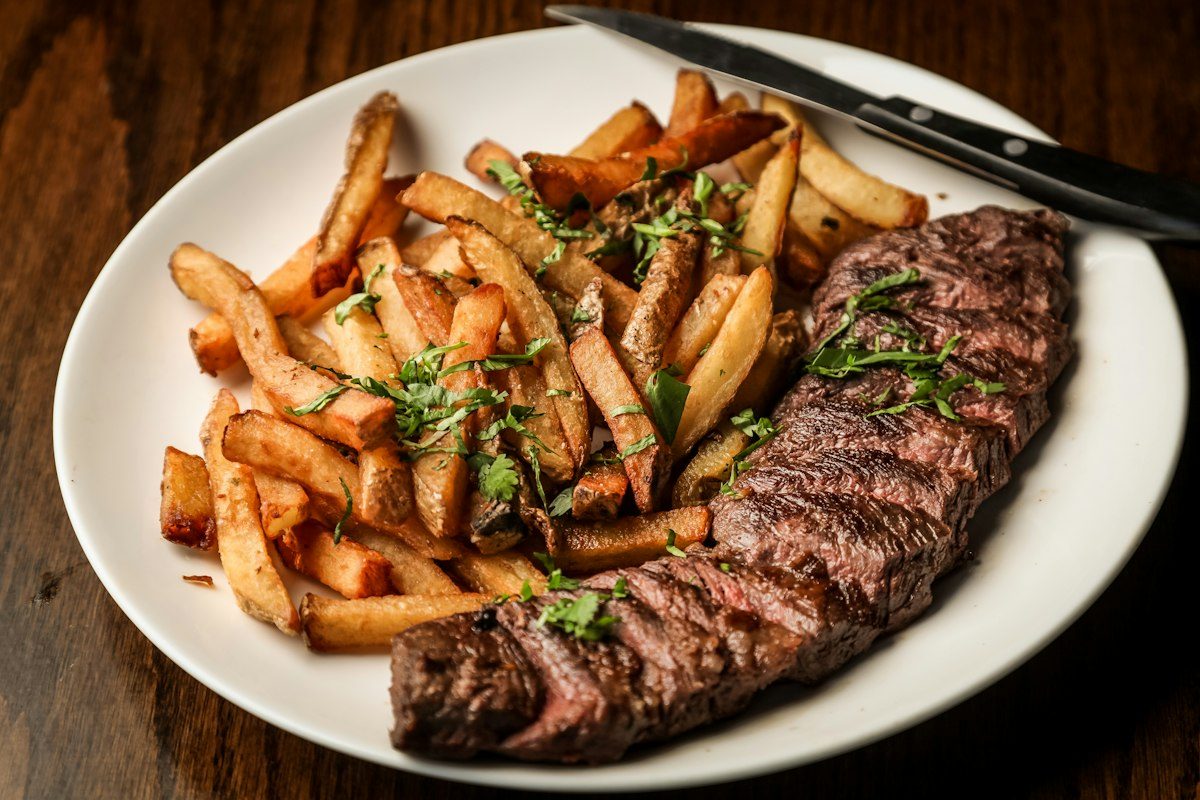 Piatto di carne alla griglia con patatine fritte